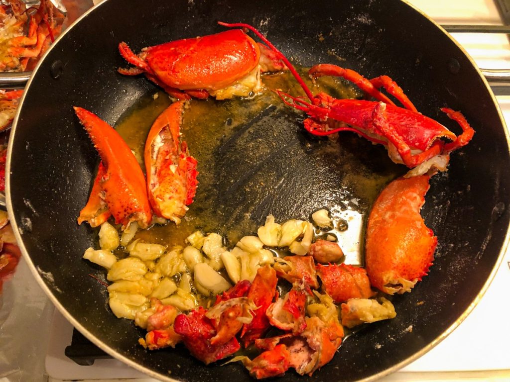 Lobster shells with garlic in black pan 