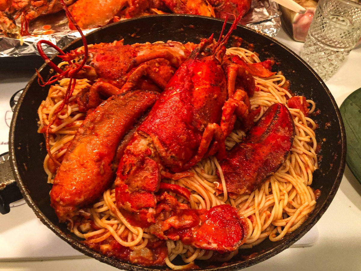 lobster in spaghetti in a black pan