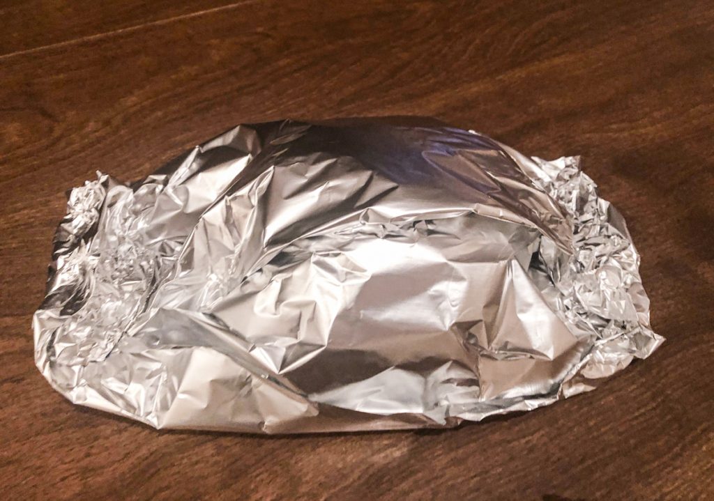 chicken wrapped in tinfoil on table