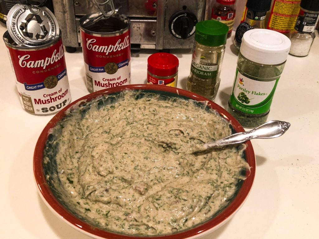 campbell's cream of mushroom soup cans behind a bowl of sauce