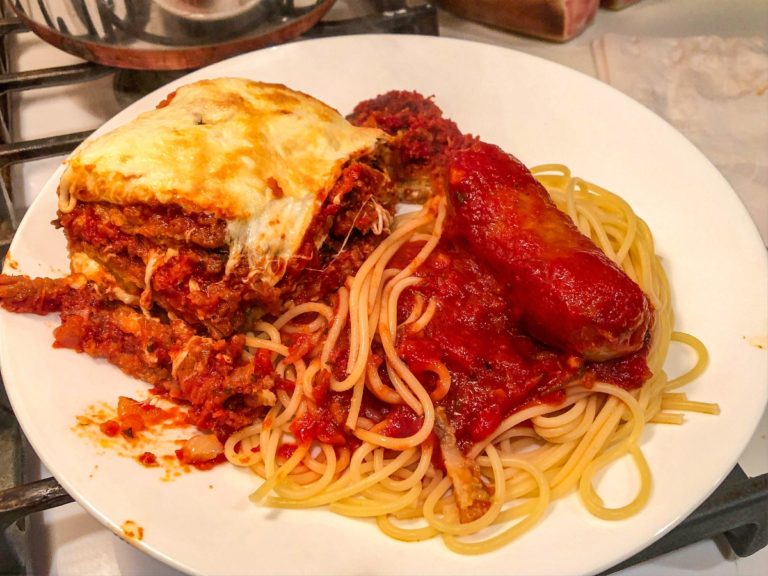 eggplant parmesan, hot italian sausage and tomato sauce over spaghetti