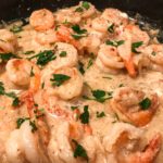 shrimp in creamy sauce in black pan
