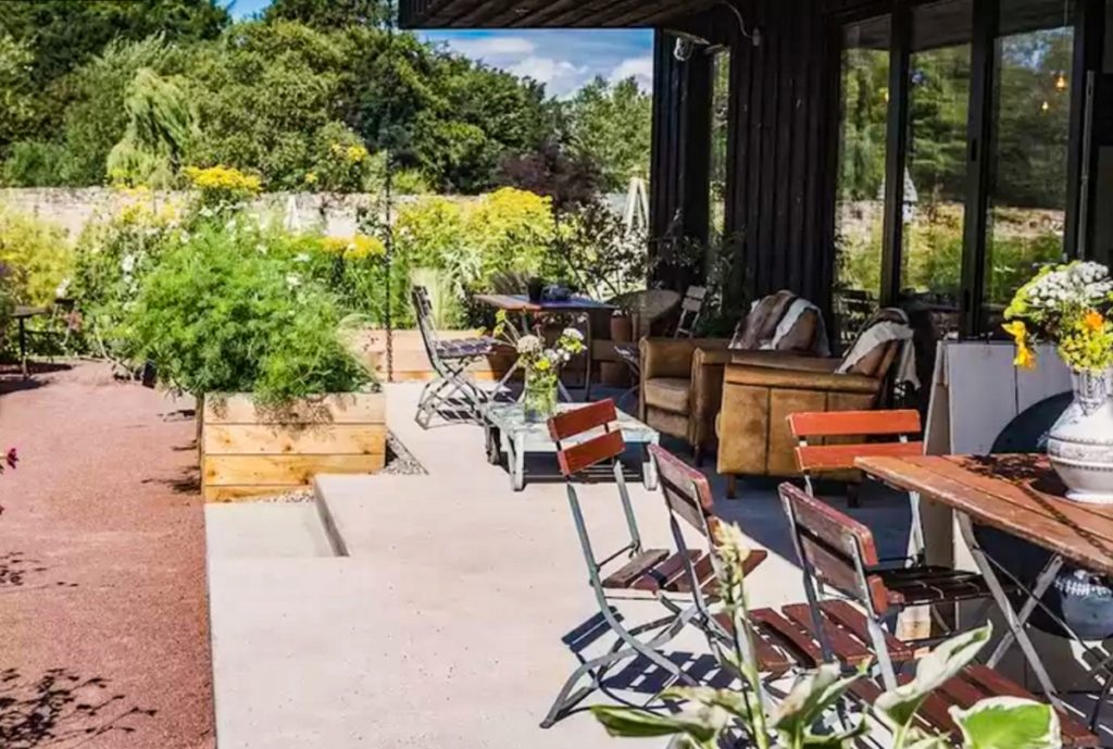 chairs and tables on the exterior of kale house