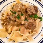 Brown meatballs over buttered egg noodles