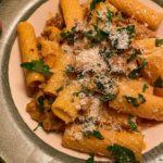 rigatoni pasta mixed with parsley and sausage