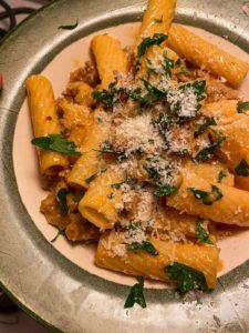 rigatoni pasta mixed with parsley and sausage
